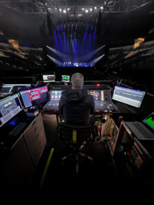 man in front of audio mixer at concert