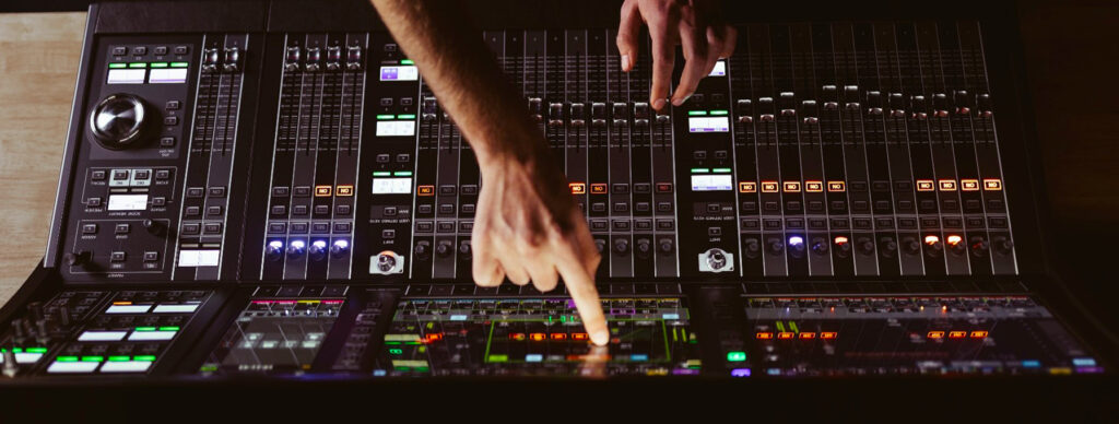 finger pointing at audio mixer