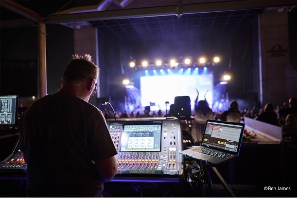 man using audio mixer at a concert