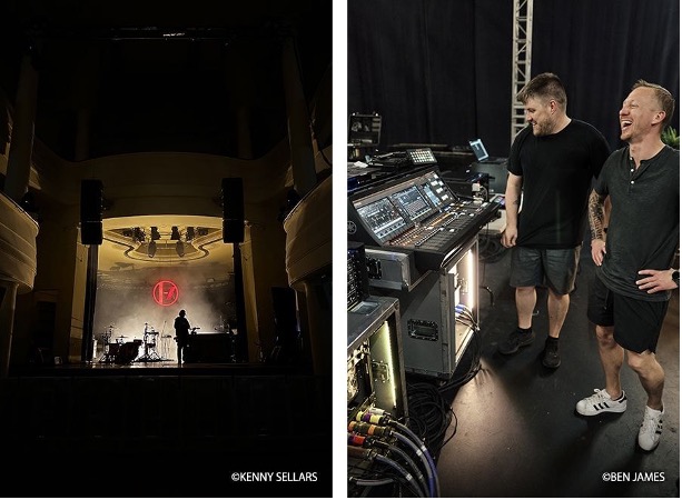 two men standing next to an audio mixer laughing and a concert