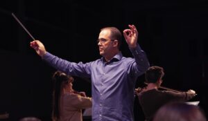 music educator conducting and holding baton