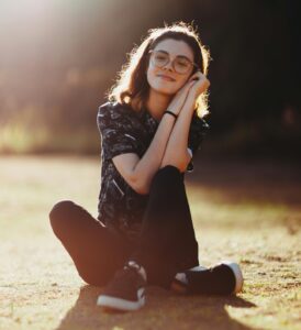 relaxed student sitting outdoors