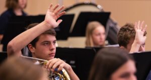 two band students holding up their hands