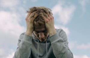 male student with head in his hands