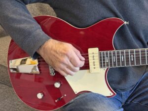 A photograph showing typical hand positioning when playing electric guitar.