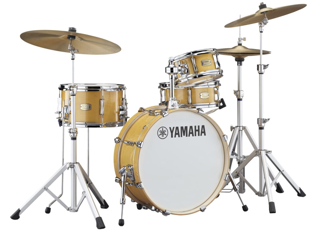 A four-piece drum set with a bass drum, snare drum, tom-tom, floor tom, high-hat and two cymbals.
