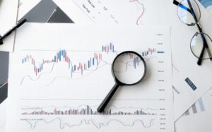 budgeting paperwork and magnifying glass on table