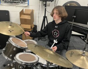 student on drum set