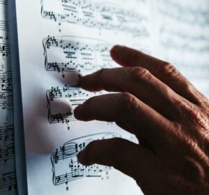 closeup of hand touching sheet music