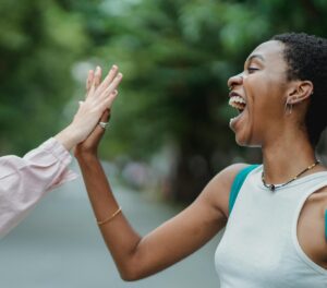 two people high-fiving