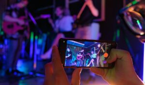 someone holding cell phone and video recording band