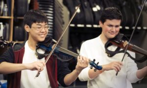 two violin players smiling