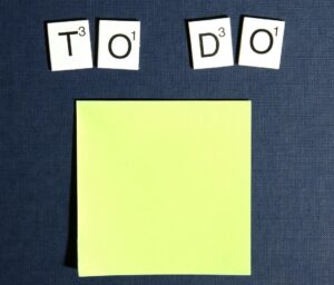 letter tiles spelling "to do" above a sticky note