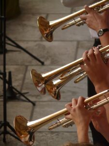 three trumpet players during rehearsal