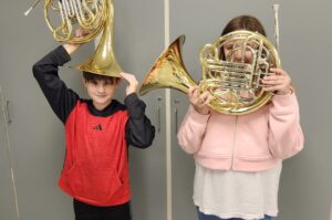 two students at Lee County's summer band camp holding French horns
