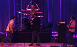 A four-piece rock band onstage.