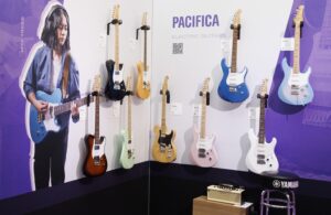 A display of Yamaha Pacifica electric guitars at a trade show.