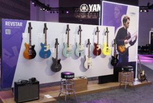 A display of Yamaha Revstar electric guitars at a trade show.