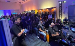 A group of people in a small room with guitar products on the wall.