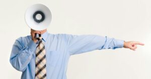 adult holding megaphone and pointing
