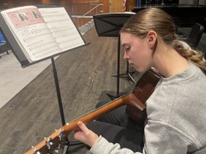 guitar student using method book