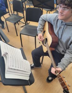 guitar student using method book