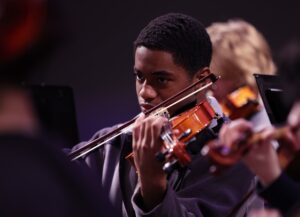Black student playing violin