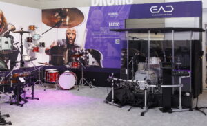 An area at a trade show showing acoustic and electronic drums.