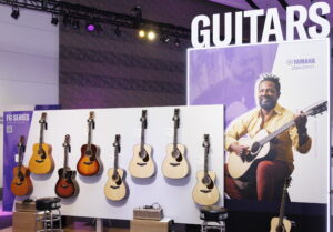 An area at a trade show showing guitars.