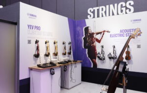 An area at a trade show showing string instruments.