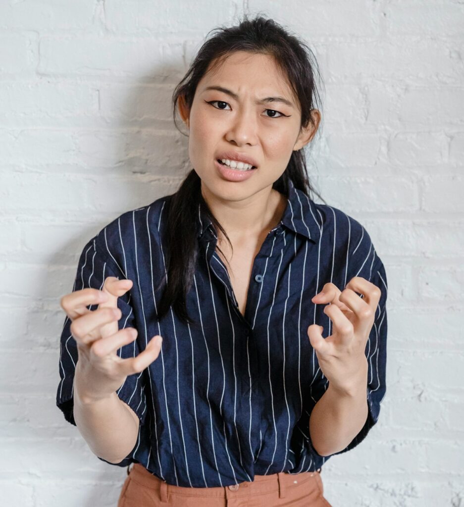 frustrated teacher with clenched hands held in front of her