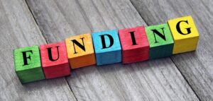 letter blocks spelling out the word "funding"