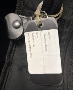 name tag and pick holder on guitar case