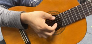 right hand ready to strum guitar