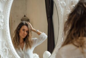 looking in mirror with melancholy look