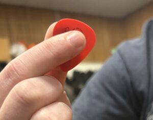 holding a guitar pick