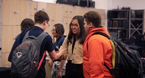 happy band students talking and smiling in band room