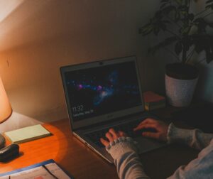 someone working on laptop at night 