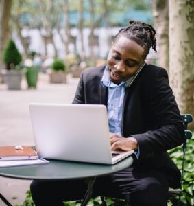man working on laptop outside