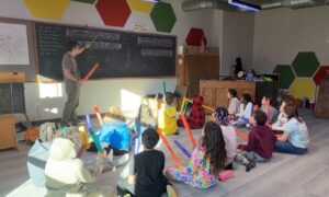 5th grade students using boomwhackers during music class