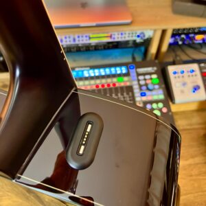 A battery charging connection on the side of an acoustic guitar.