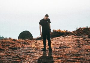 man standing outdoors alone