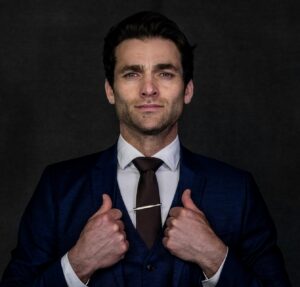 proud man in suit with hands holding jacket's lapels