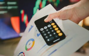 hand holding calculator and paper
