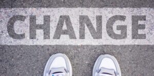 someone standing in front of the word "change" painted on the ground 