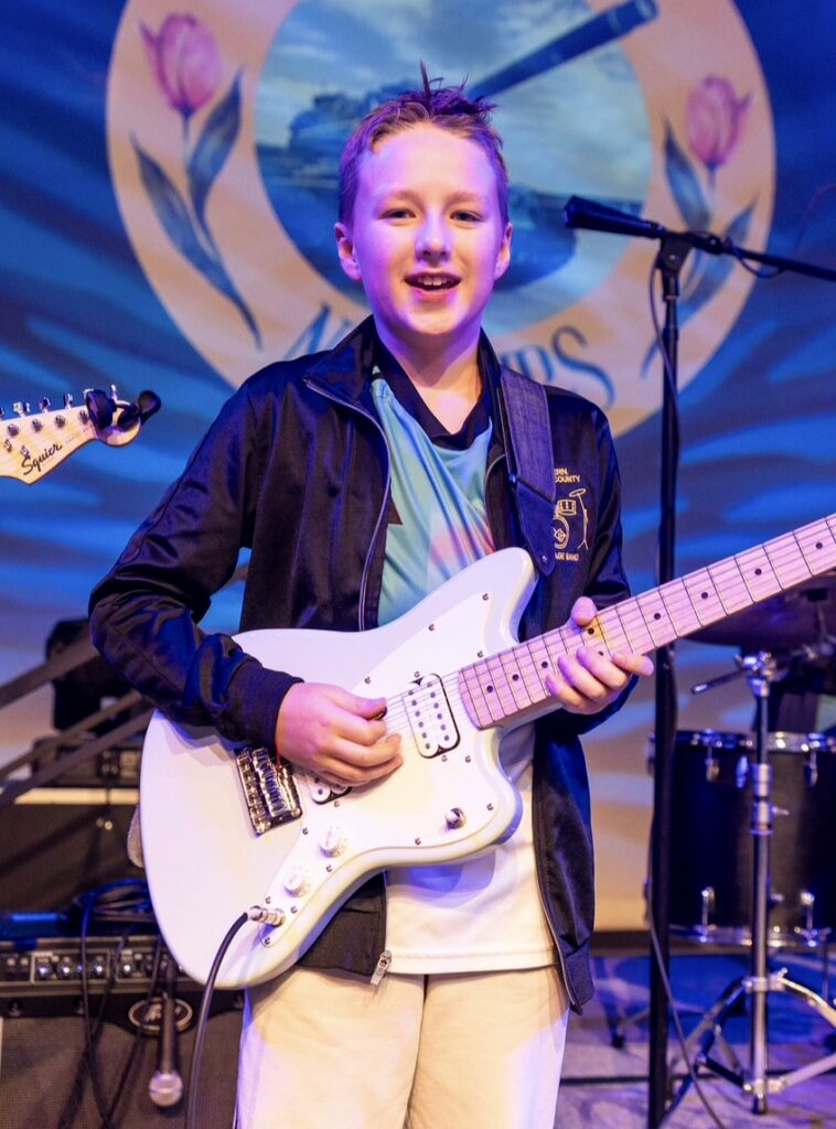 student playing electric guitar