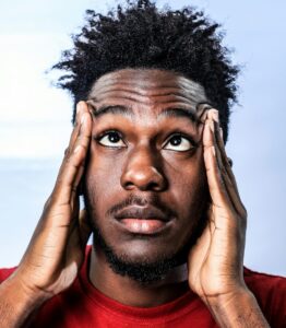confused man with hands on either side of his face