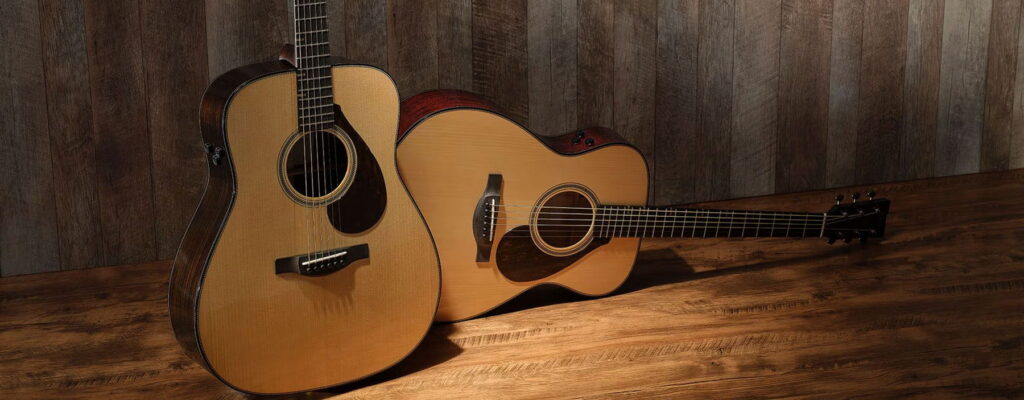 Two Acoustic guitars laying on a stage