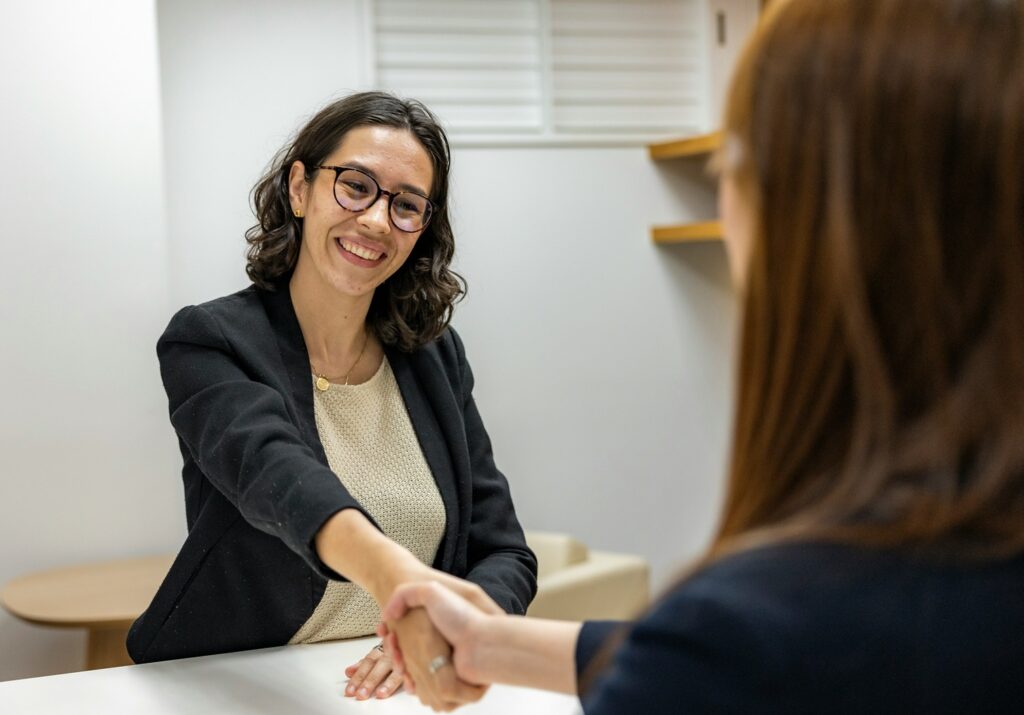 two women shaking hands for an interview