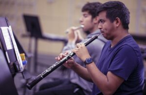 students playing the oboe and flute during rehearsal